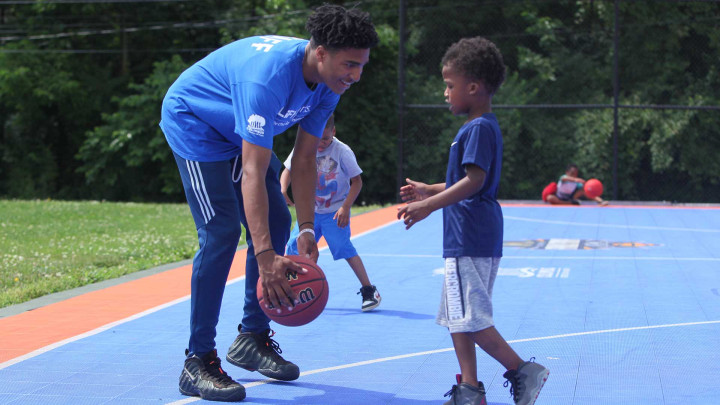 Man teaching youth basketball