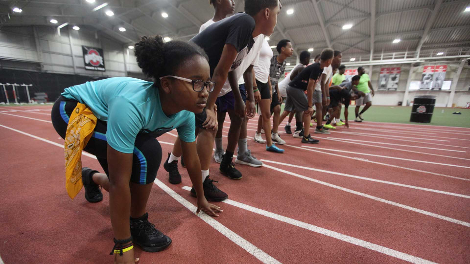 Group of kids lining up on a track starting point