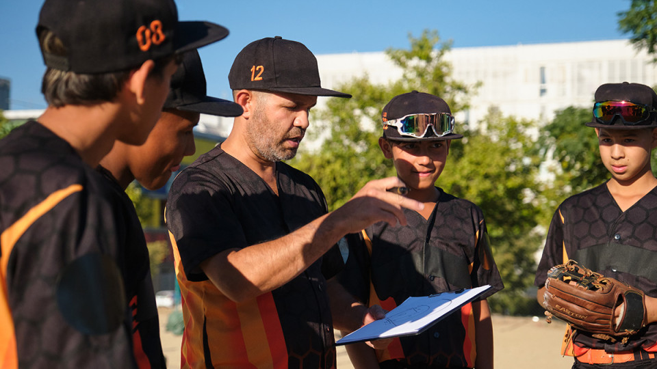 baseball coach discussing gameplan with team